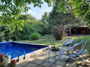 a patio with two chairs and a swimming pool at Jagodinska Oaza in Jagodina