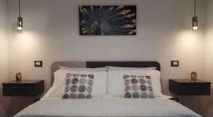 a bedroom with a large bed with two night stands at MiBu House in Palazzolo Acreide