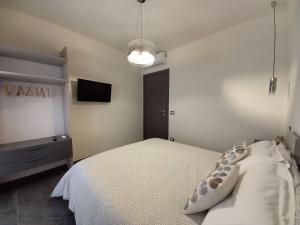 a bedroom with a bed and a flat screen tv at MiBu House in Palazzolo Acreide +27 photos