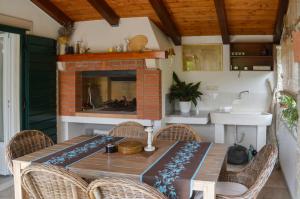 a dining room with a table and a fireplace at ISSA Holiday Home - 3 Min Walk to Beach in Kaštela