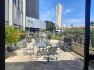 un patio con tavolo e sedie su un edificio di Tatuapé flat services, ótima localização a San Paolo