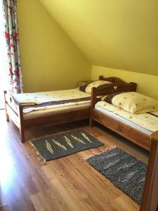 Postel nebo postele na pokoji v ubytování DOMEK LETNISKOWY NA MAZURACH