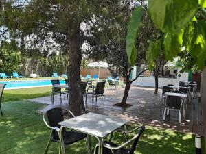 a group of tables and chairs next to a pool at Aqua House in Denia
