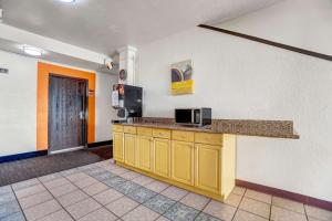 a room with a kitchen with a counter and a microwave at Motel 6-Moriarty, NM in Moriarty