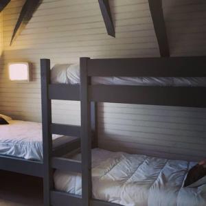 a bedroom with two bunk beds in a house at Gîte château d'Espalungue, piscine et SPA in Dognen