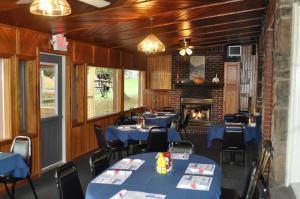 a dining room with blue tables and a fireplace at Lakewood Lodge & Restaurant in Lakewood