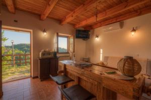 a large kitchen with a counter and a large window at Cà du Venuto 2 in Vernazza