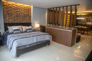 a bedroom with a bed and a dining room at Business SUITES KEPLER in Mexico City