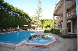 a swimming pool in front of a house at Al Fardous Luxury Vacation Home in King Mariout