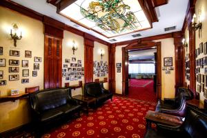 a waiting room with leather chairs and a skylight at Hotel Golden House in Craiova