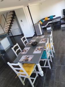 a classroom with a table and chairs and a staircase at KERKASA Grande maison en campagne proche Rennes, 2100m² in Tresboeuf +16 photos
