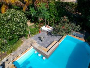 een uitzicht over een zwembad in een tuin bij Jardim Secreto Guest House in Búzios