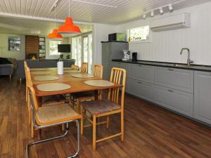 Helberskovにある8 person holiday home in Hadsundのキッチン(木製のテーブル、椅子付)