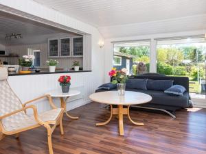 een woonkamer met een bank en een tafel bij 8 person holiday home in rsted in Ørsted