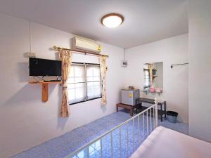 a room with a staircase with a television and a window at ระเบียงทะเล รีสอร์ท in Phetchaburi