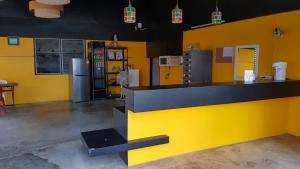 a kitchen with yellow walls and a yellow counter top at ระเบียงทะเล รีสอร์ท in Phetchaburi
