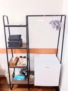 a white refrigerator on a shelf next to a wall at Joya in Ishigaki Island