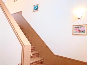 a staircase in a building with a picture on the wall at Joya in Ishigaki Island