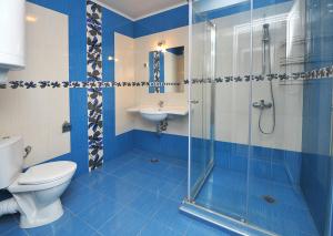 a bathroom with a shower and a toilet and a sink at Студио Калина in Pomorie