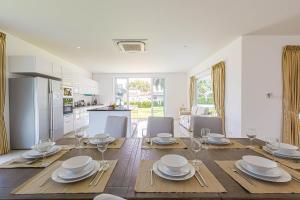 a kitchen and dining room with a table and chairs at Amazing Private 6 Bedroom Pool Villa ED60 in Khao Tao