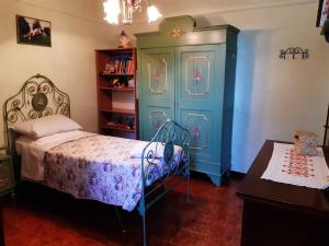a bedroom with a bed and a blue cabinet at B&B MAMMA ARI in Fermo