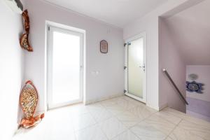 an empty room with a door and a tile floor at Vila Adriana in Eforie Nord +120 photos