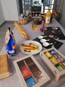 a table with food and bread and a plate of food at B&B Colvestre in Tréguier +16 photos
