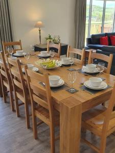 a wooden table with chairs and a dining room at Valley View Cottage in Rothbury