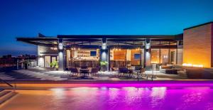 a house with a swimming pool at night at The Last Hotel in Saint Louis