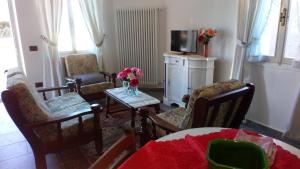a living room with chairs and a table and a tv at House in The Calm Nature of Prosecco Valley in Revine Lago