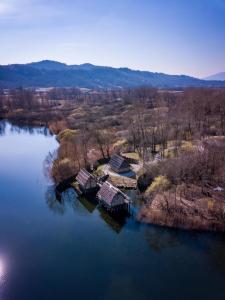 an aerial view of a house on a island in a lake at House in The Calm Nature of Prosecco Valley in Revine Lago