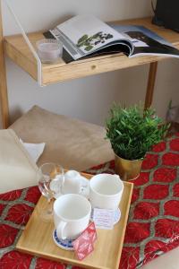 a wooden tray with cups and cups on a table at B&B Palazzo de "Il Nuovo Duca Minimo" in Pescara