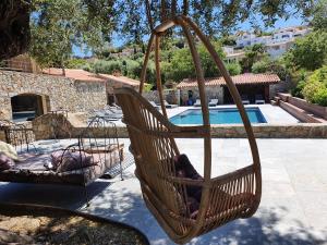a hammock swing in front of a swimming pool at La Bergerie in LʼÎle-Rousse