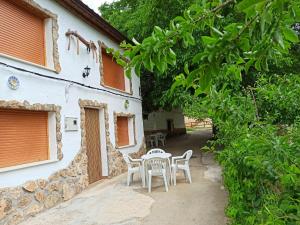 a patio with chairs and a table in front of a building at Cortijo Ramón petra ll in Nerpio