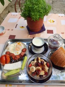 a tray of food with vegetables and bread on a table at Vrenjo GuestHouse in Gjirokastër