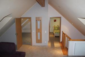 an attic room with a staircase and an open door at Landhaus Monika in Plütscheid