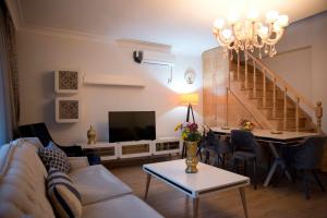 a living room with a couch and a dining room at Nupelda Residence Hotel in Istanbul