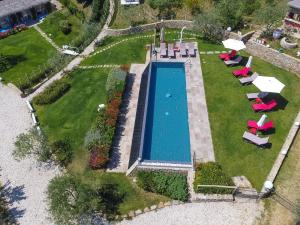 a patio area with a pool and lawn chairs at Podere Fontanino in Arezzo
