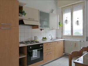 a kitchen with a stove and a sink at Vistalago 55 B in Como