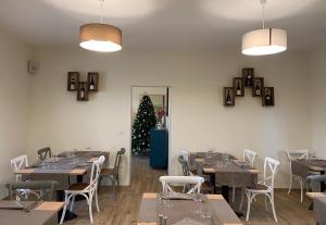 a dining room with tables and chairs and a christmas tree at Controvento in Casalbordino