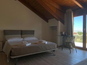 a bedroom with a bed with a chair and a window at Controvento in Casalbordino