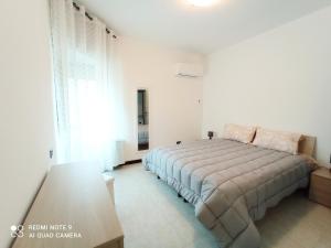 a bedroom with a bed and a large window at Casa del Parco in Olbia