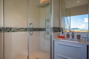 a bathroom with a shower and a sink at Hotel Restaurant Les Venetes in Arradon +54 photos