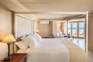 a hotel room with a large bed and a large window at Hotel Guadalmina, managed by Barceló Hotel Group in Marbella