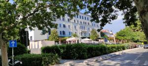 a large white building with a street sign in front of it at Blue Stella Luxury Apartment in Split