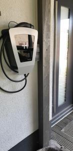 a television hanging on a wall next to a door at Eubaer Straße in Niederwiesa +7 photos