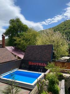 a swimming pool in the backyard of a house at Неотель in Krasnaya Polyana