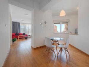 a dining room and living room with a table and chairs at Seaside Rest Apartments in Budva
