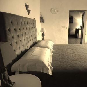 シナルンガにあるPodere Pievina Delle Corti - Dimora di Campagnaのベッドルーム1室(ベッド1台、パッド入りのヘッドボード付)