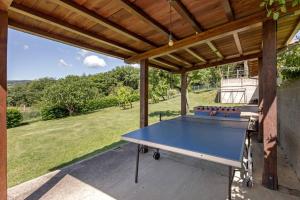 a ping pong table on a patio under awning at ABETE in Pratovecchio